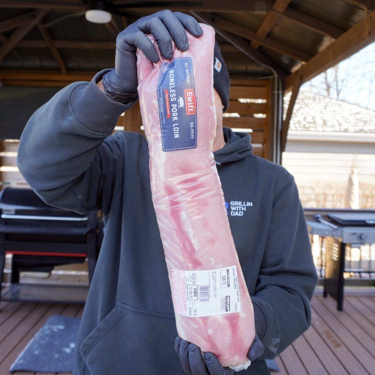 packaged pork from costco held in hands to show size of the cut.