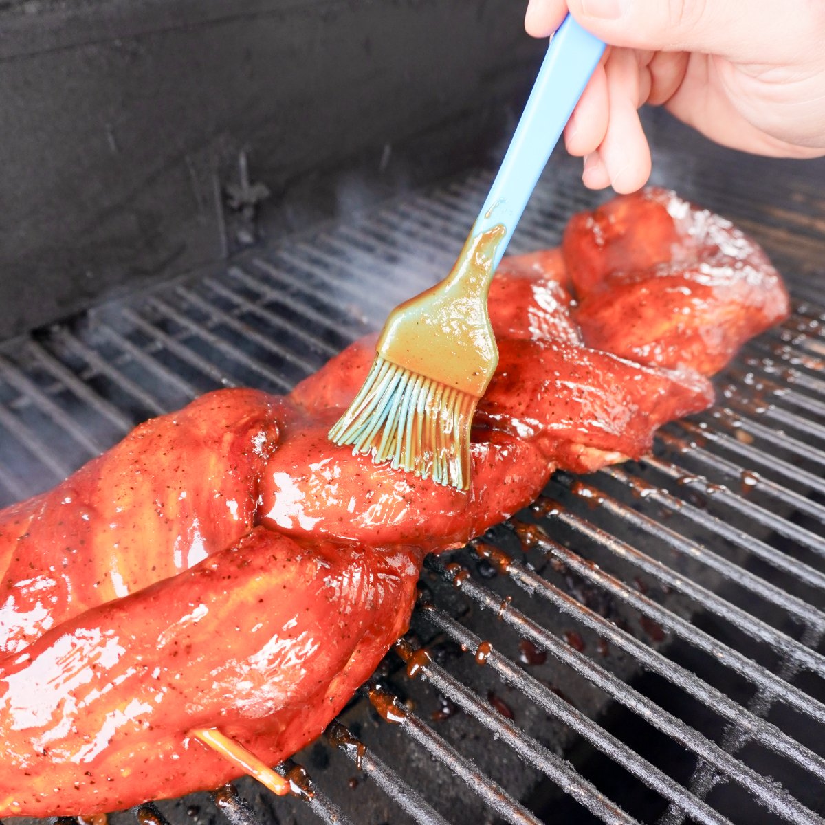 grilled pork on the grill and brushed with BBQ sauce.