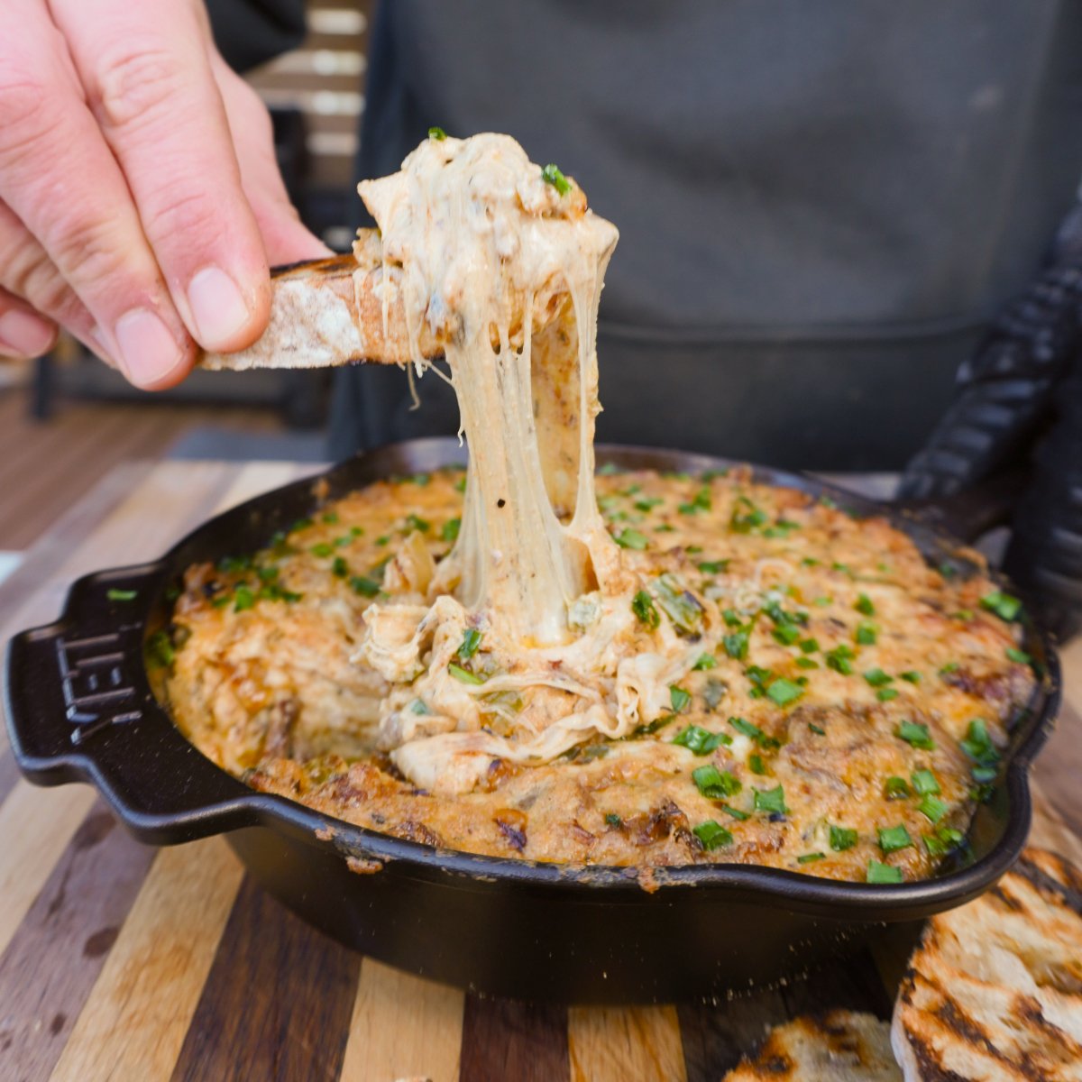 showing off the cheese pull with a toasted crostini.