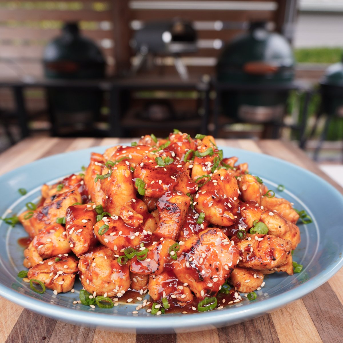 Plated sweet chili chicken bites on a light blue plate.