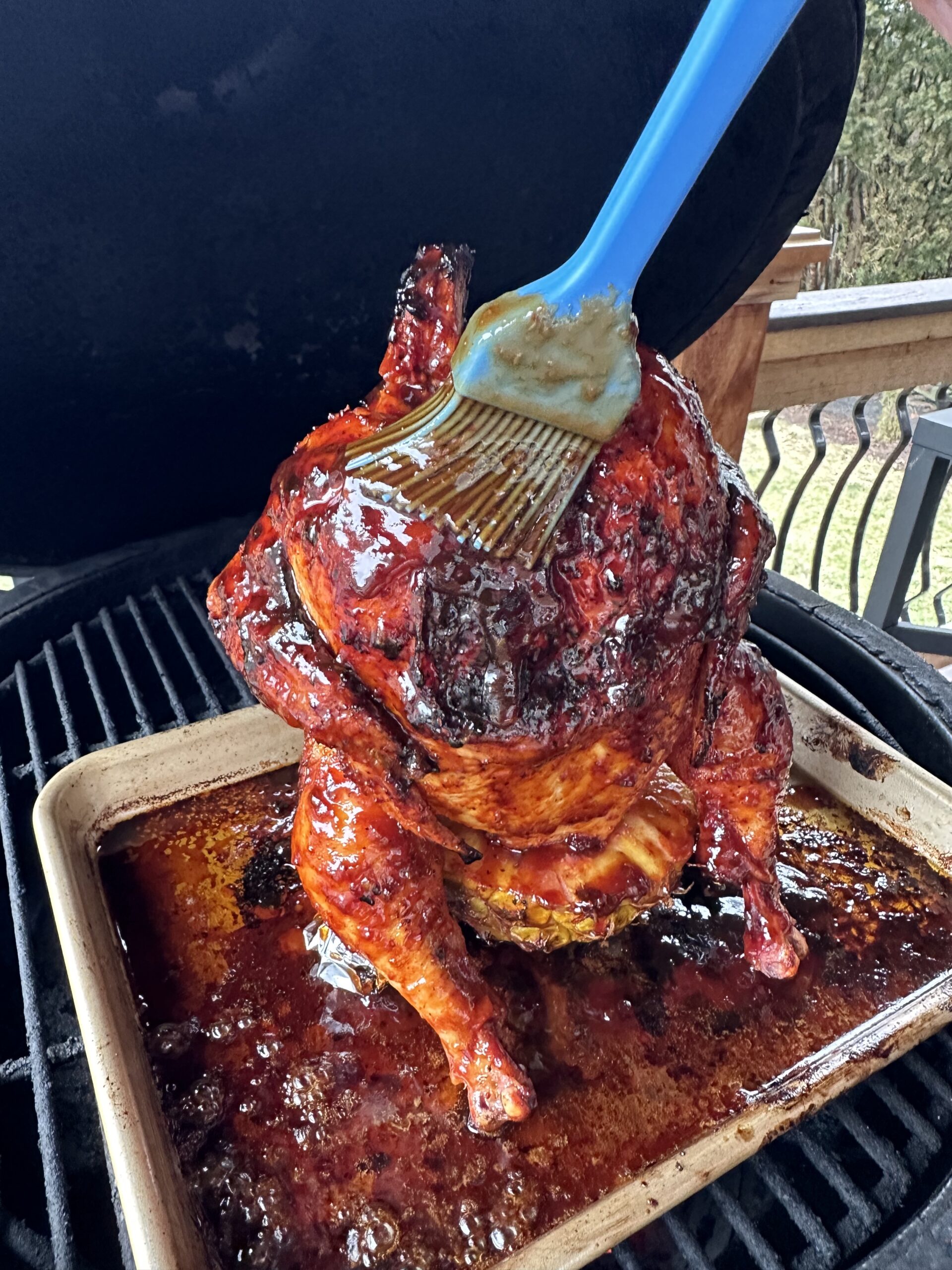 Huli Huli sauce being applied to chicken. 