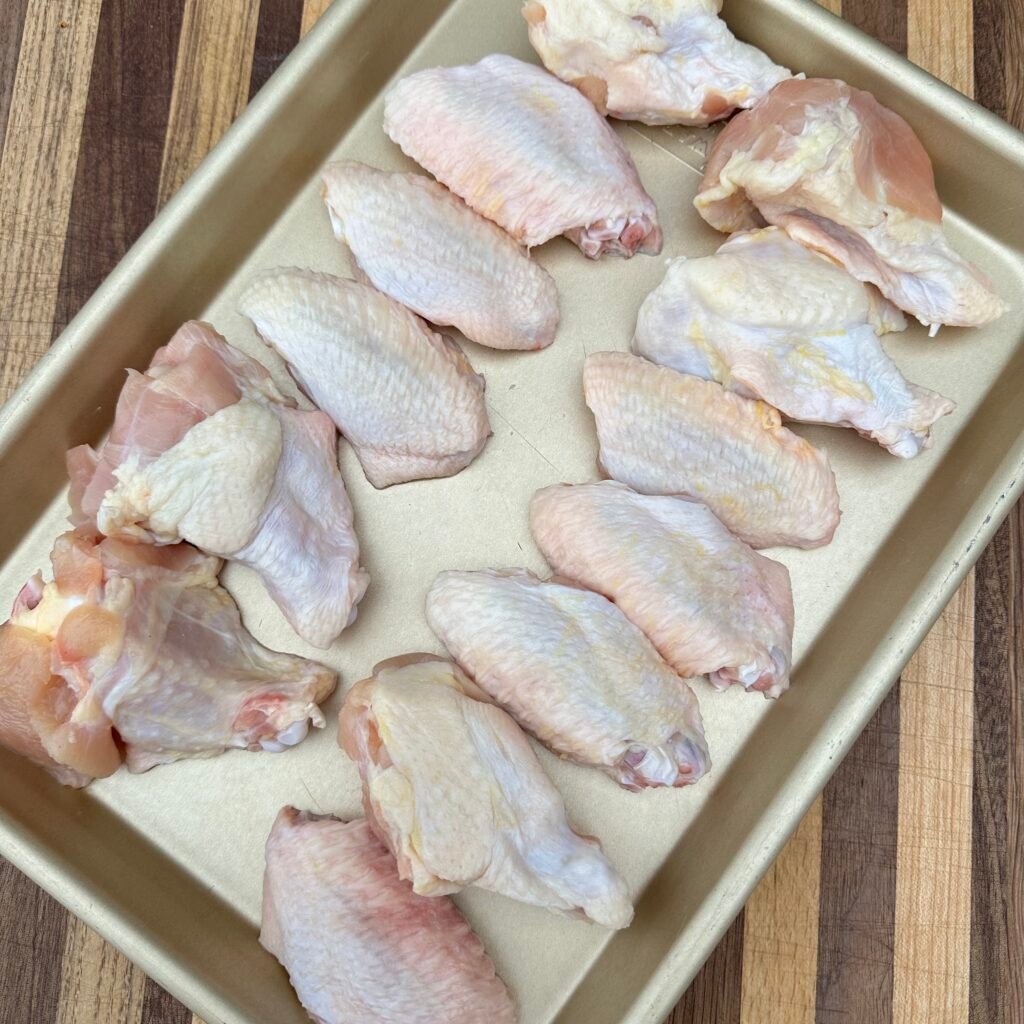 Raw chicken wings on a sheet pan. 