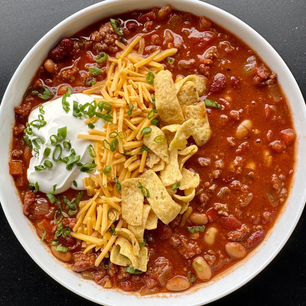 over the top beer chili dressed with fritos, cheese and sour cream.