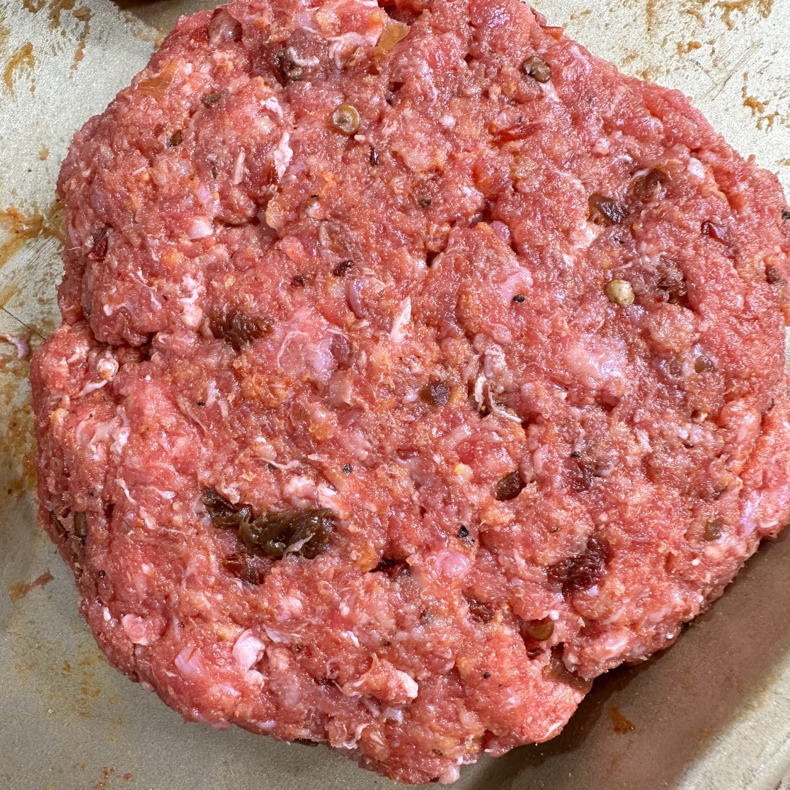 Raw Chipotle beef patty.