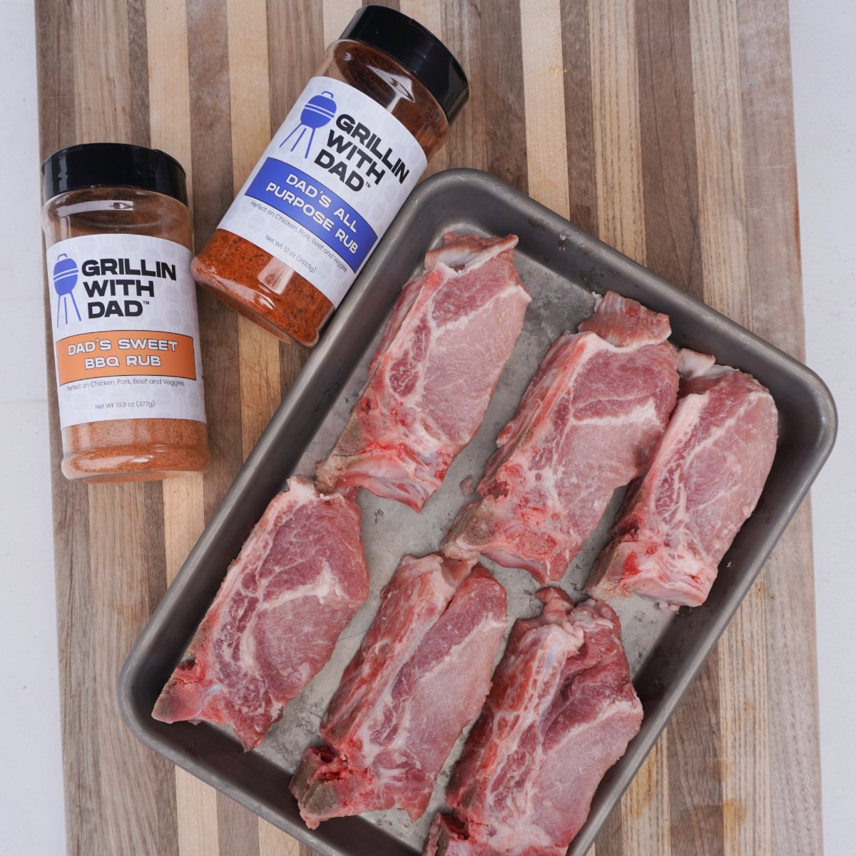 country style ribs on a tray and bbq seasoning. 
