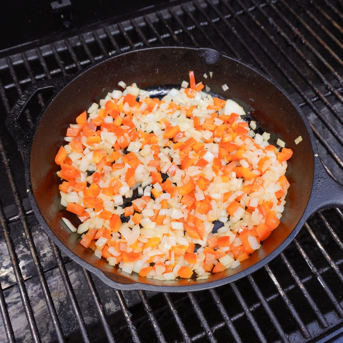 sauteed veggies in a cast iron skillet on the grill