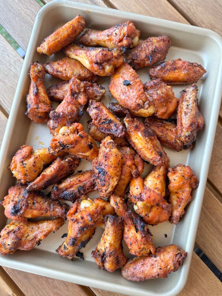 dry rub wings on a metal sheet pan.