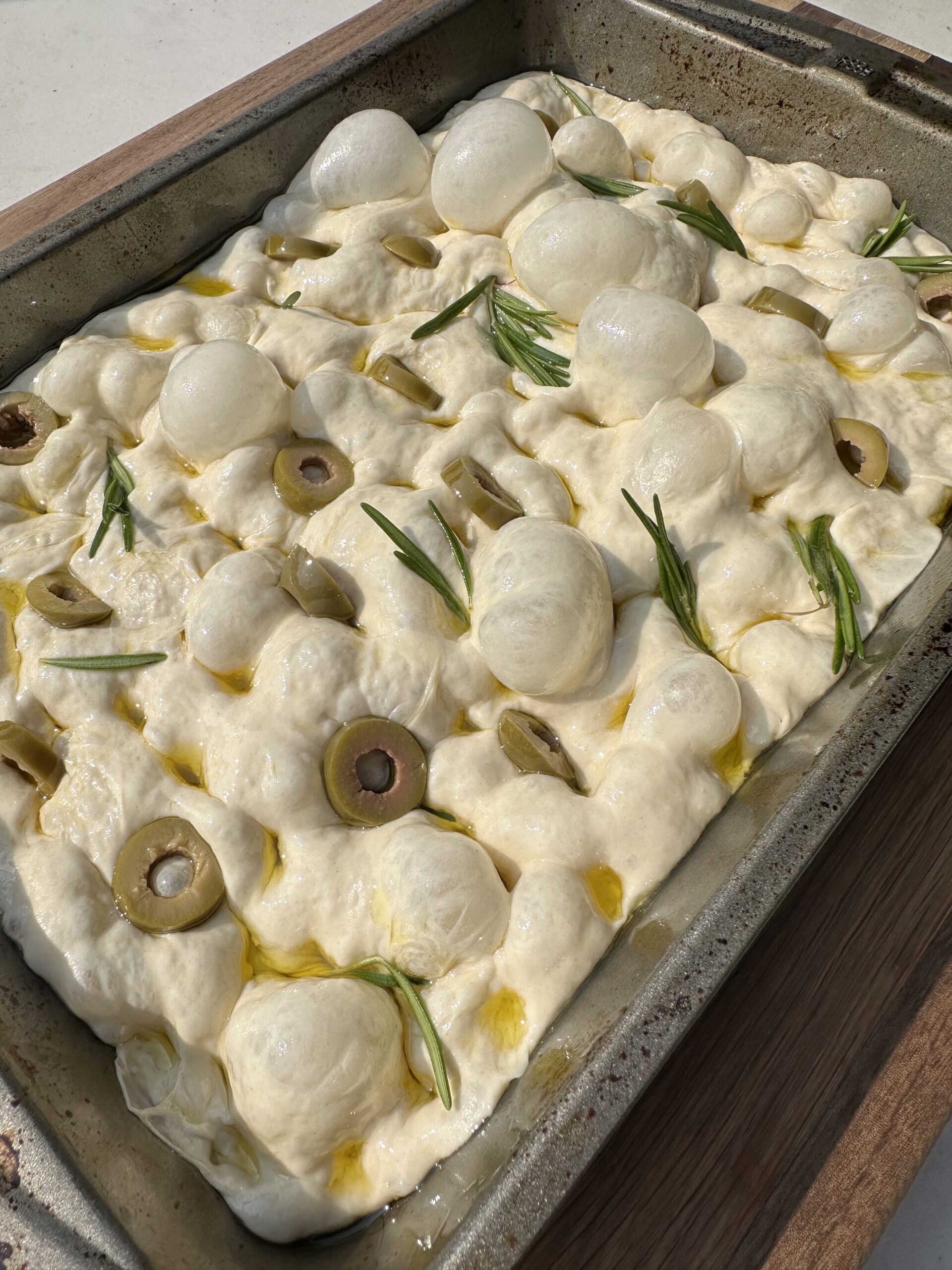 Raw focaccia bread with herbs