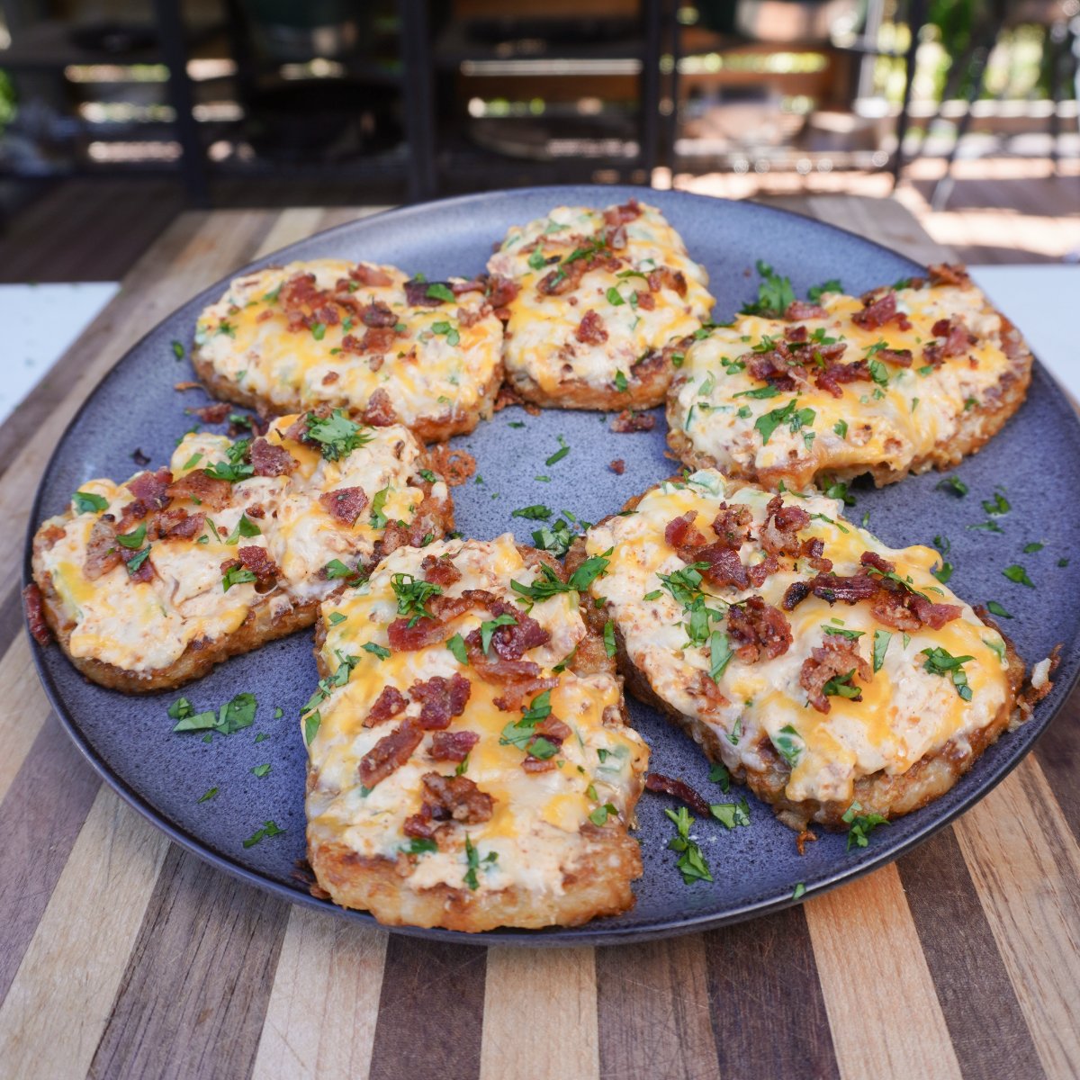 Finished jalapeno popper hash browns on a round grey plate.