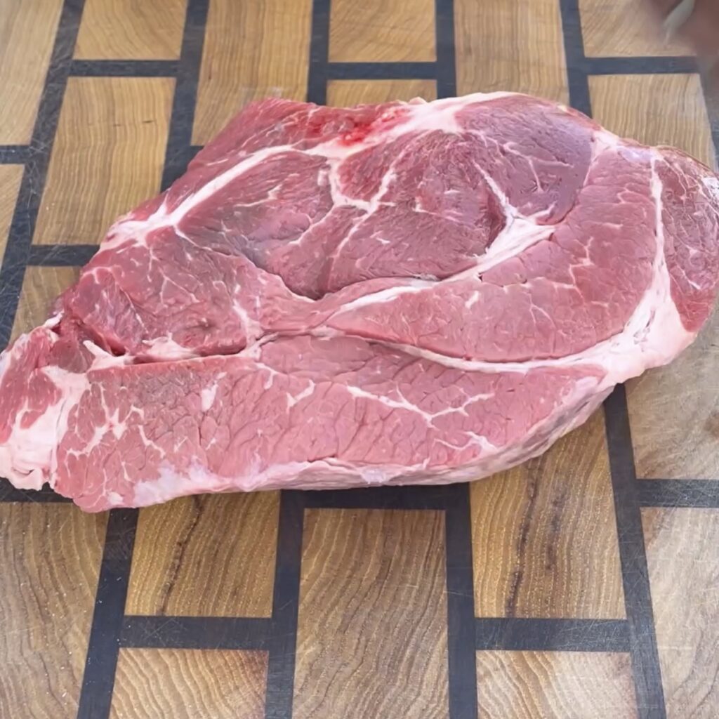 beef chuck roast on cutting board. 