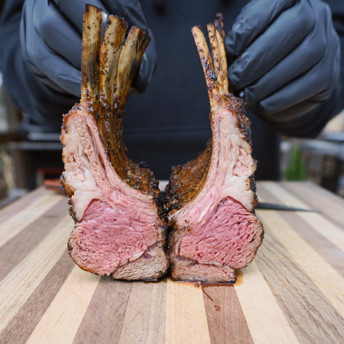 sliced in half  rack of lamb cooked to a perfect medium rare.