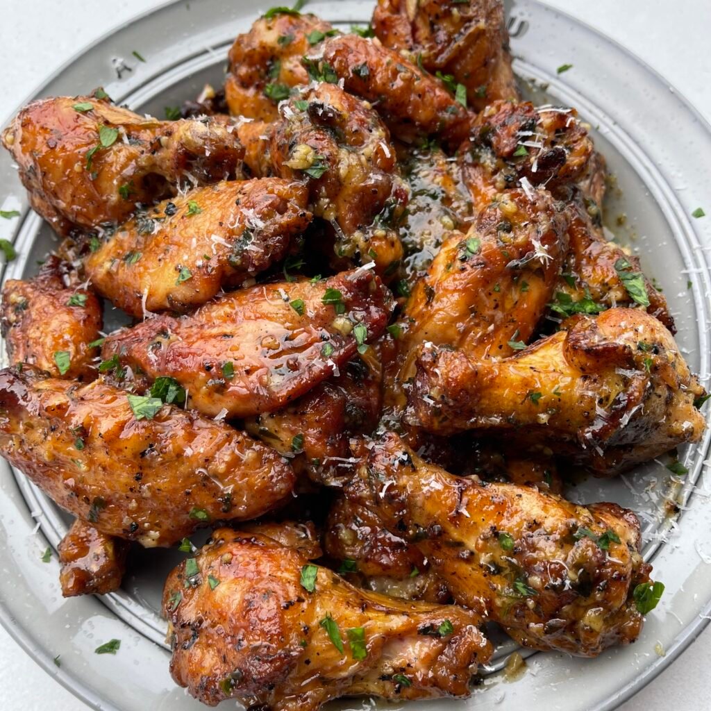 grilled lemon garlic wings on a plate. 