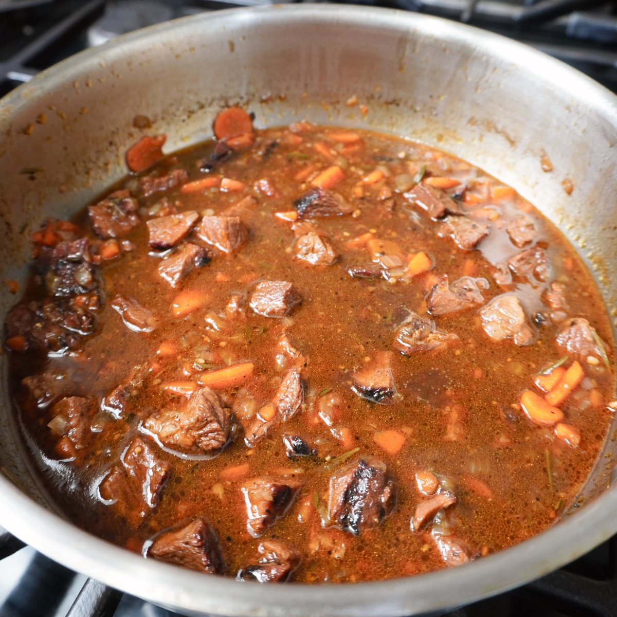 smoked meat pie gravy in a metal saucepan.