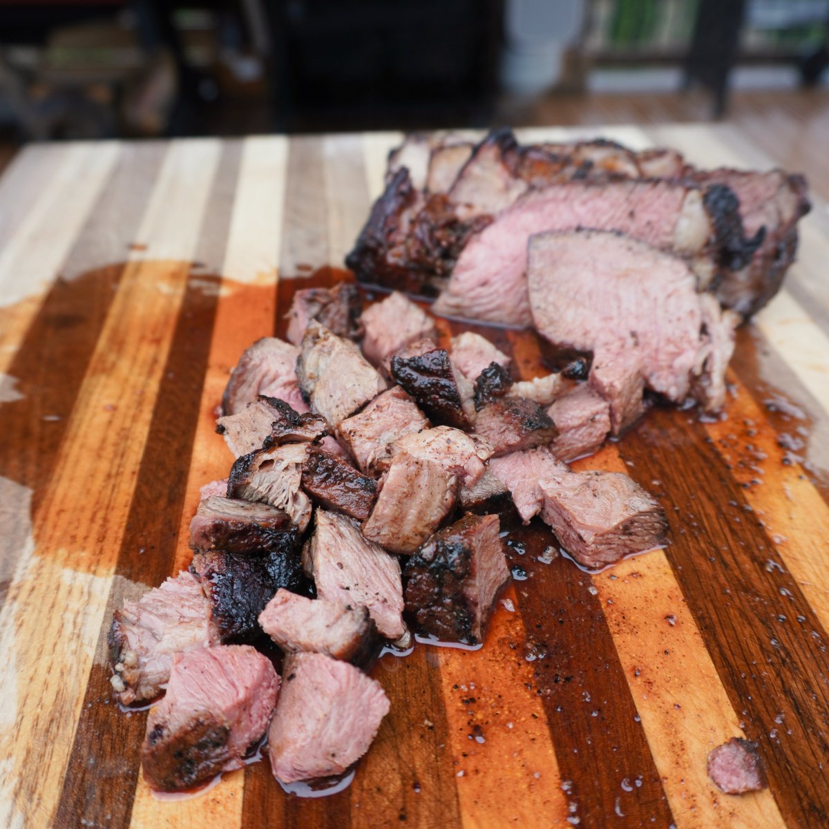 chopped up smoked chuck roast on a wooden cutting board.