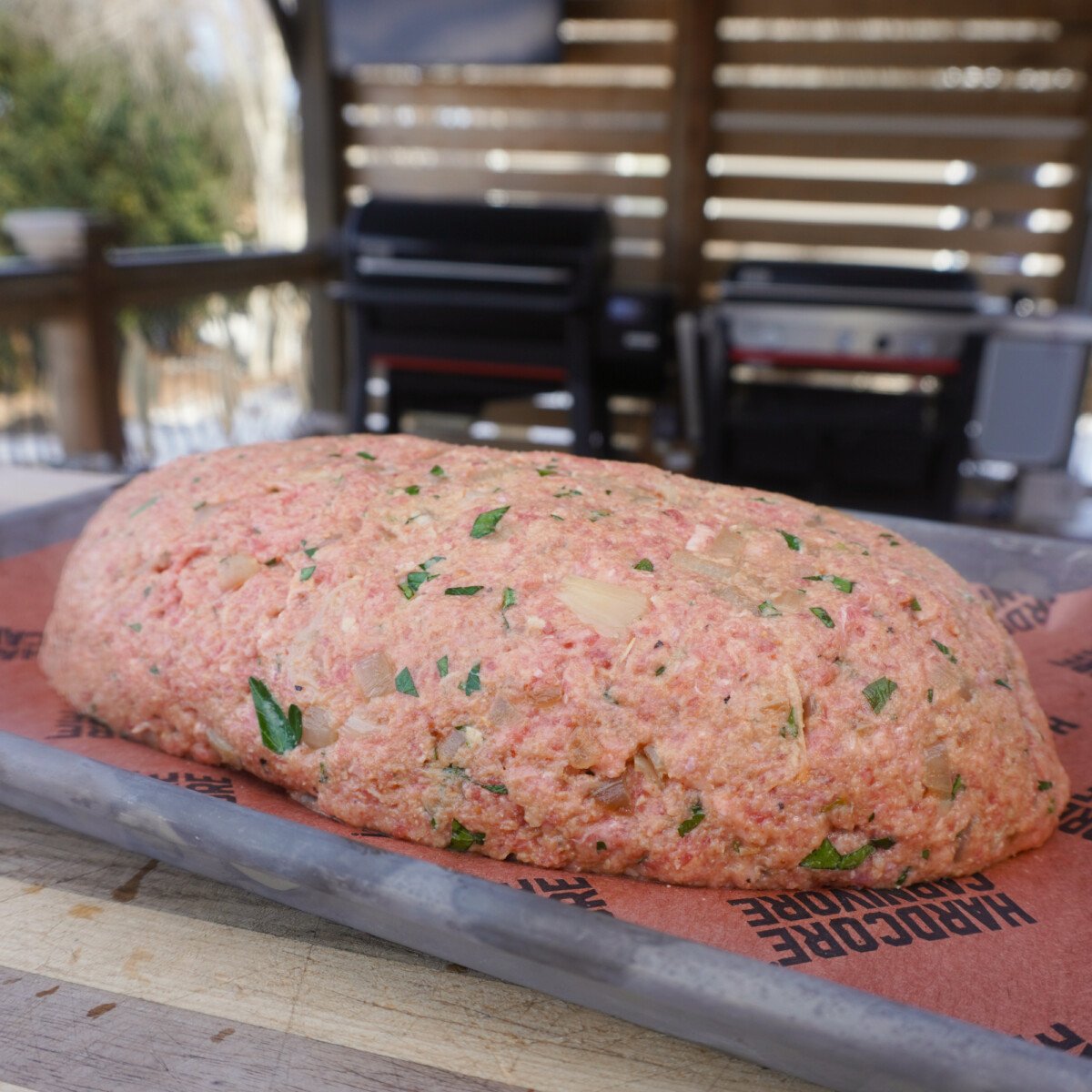 oval shaped raw meatloaf.