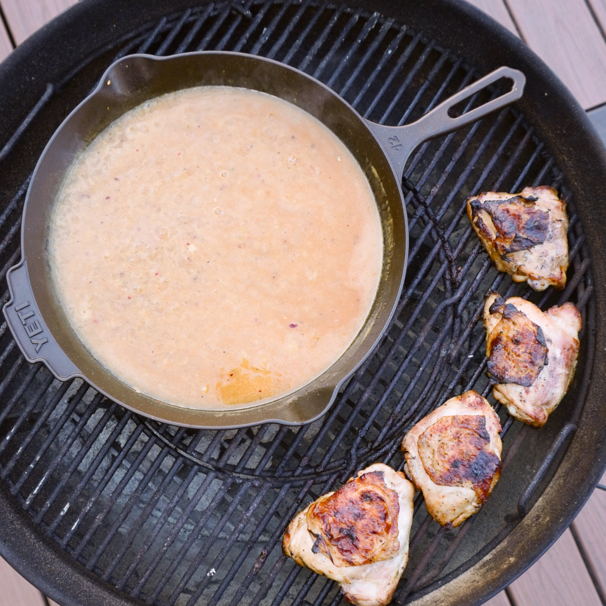 chicken and skillet on the grill. 