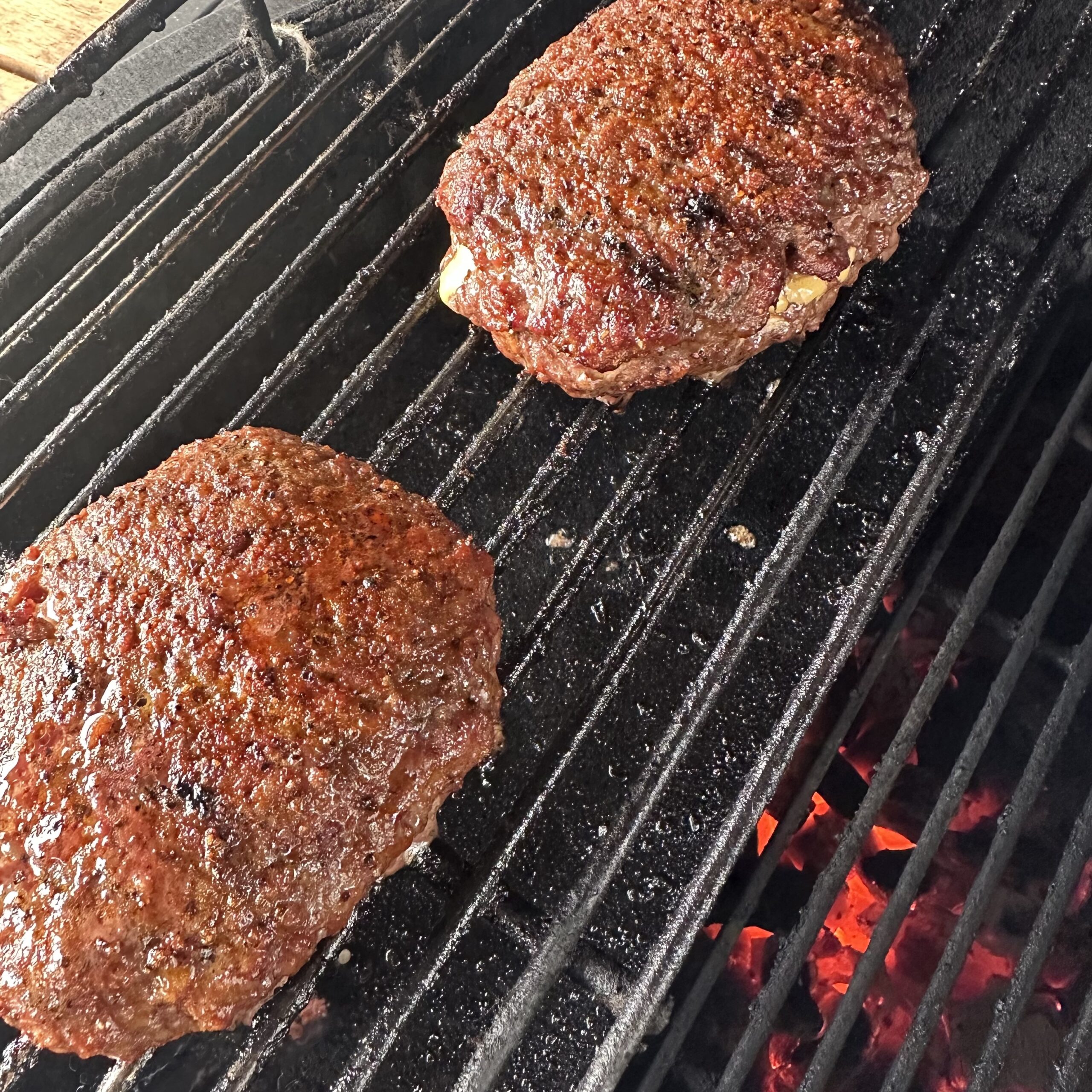 Juicy Lucy burger patties on grill