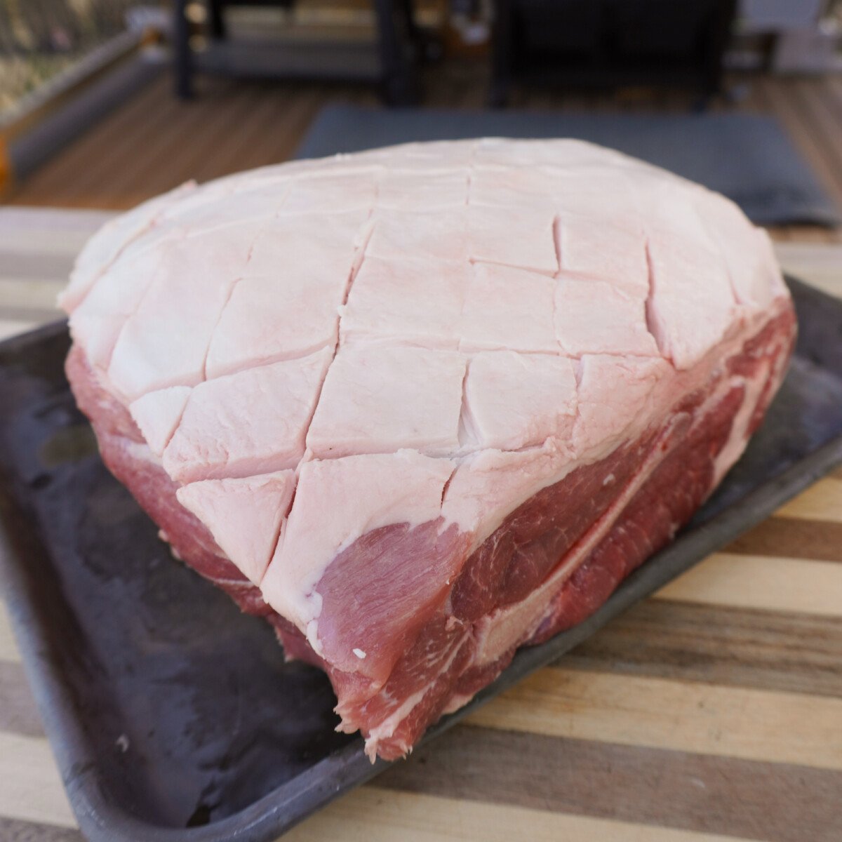 Checkered pattern on the fat cap of a pork shoulder.
