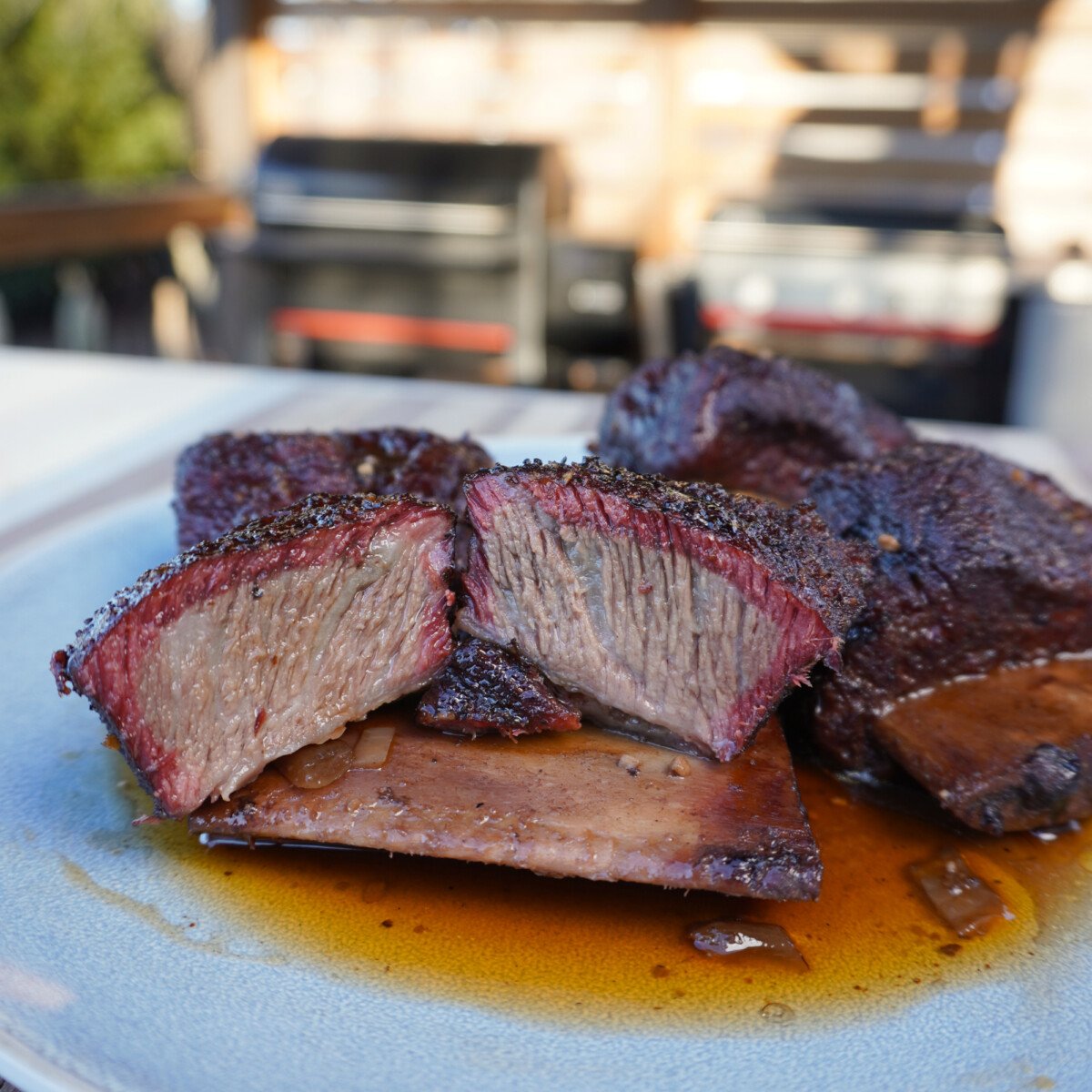 smoked short ribs, cut in half on a plate. 