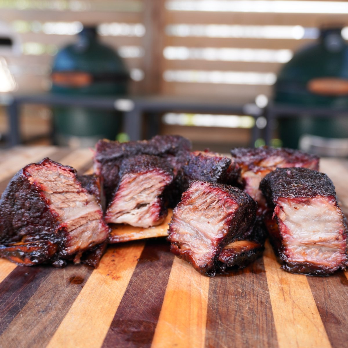 Final beef short rib bites on a wooden cutting board.