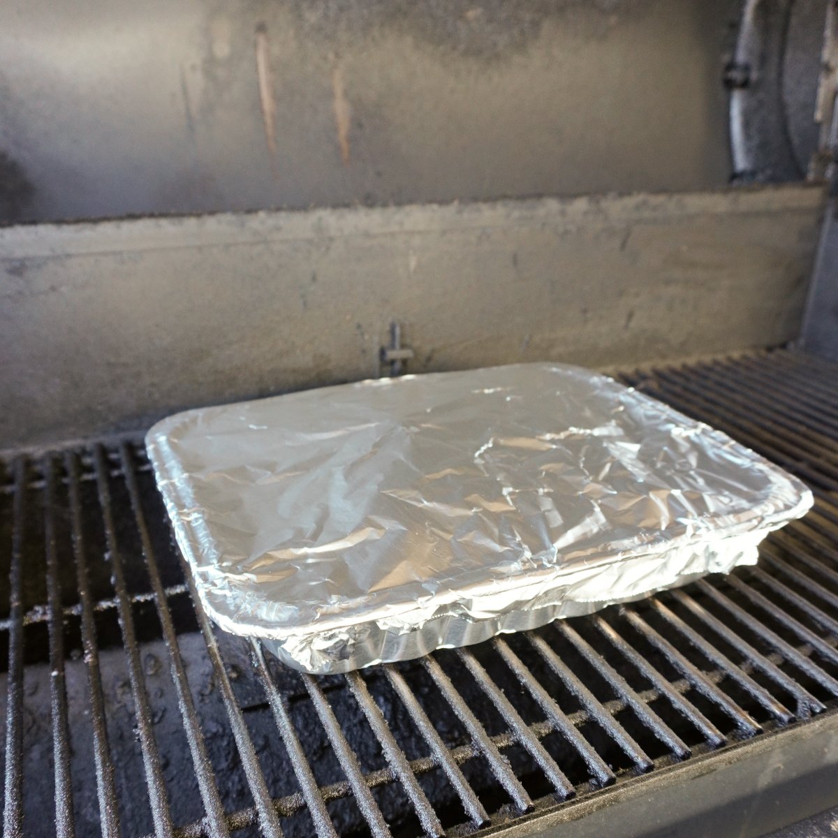 foil pan wrapped in foil on the smoker. 
