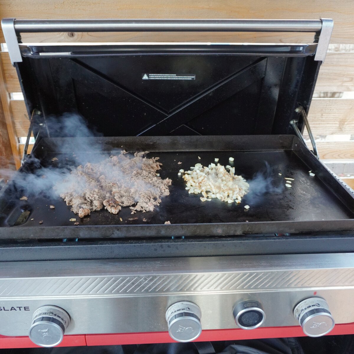 Sliced ribeye steak and onions on the griddle.