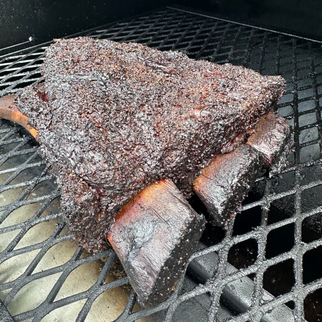 Beef ribs smoking on a smoker. 