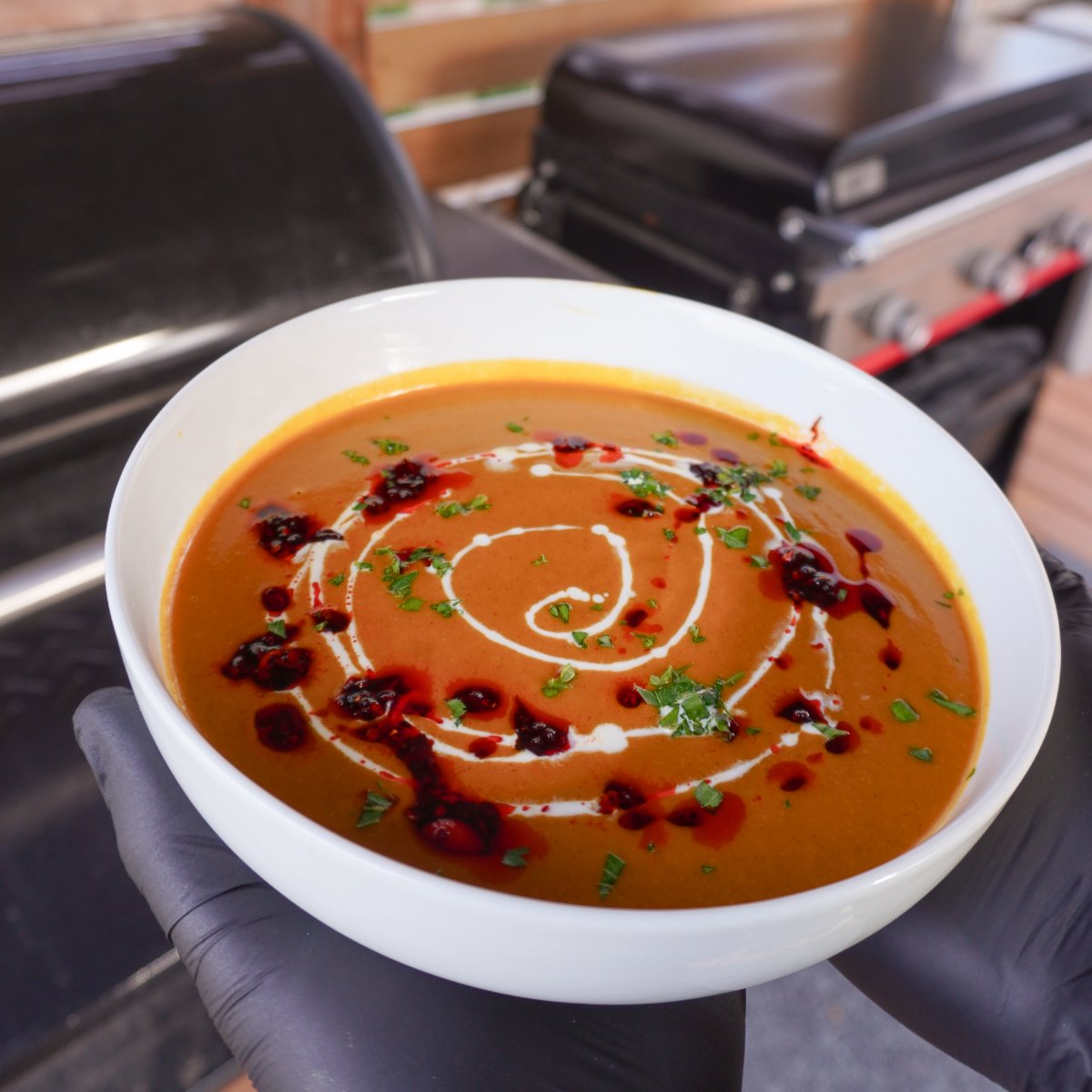 butternut squash soup plated in white bowl.