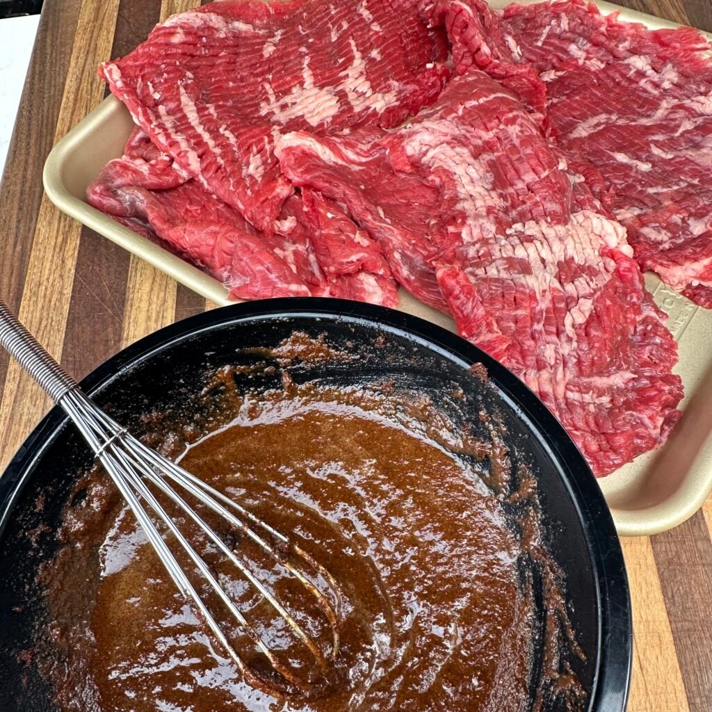 skirt steak and marinade in a bowl.