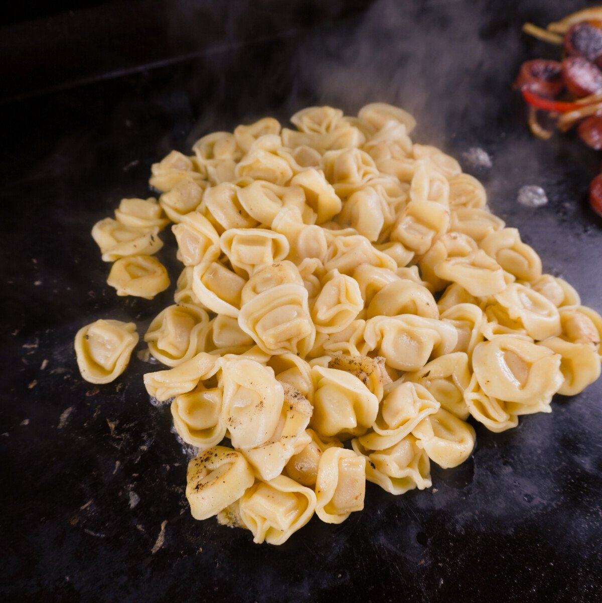 frozen precooked tortellini on the griddle.
