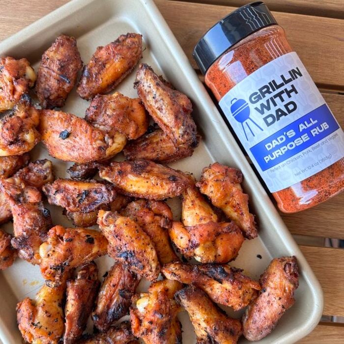 Seasoned and grilled wings on a tray.